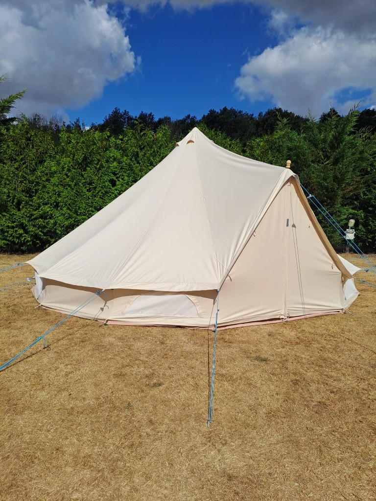 Row of canvas bell tents for an outdoor festival-style stay