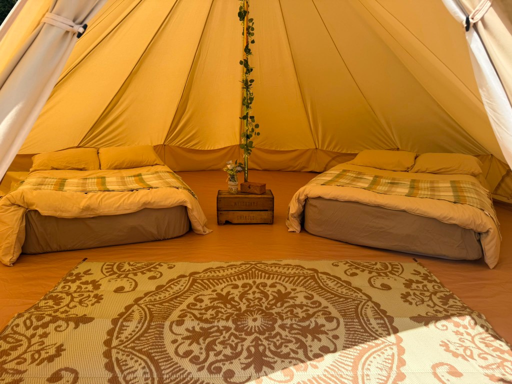 Furnished bell tent interior for overnight wedding guests